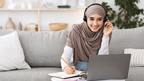 vrouw met hoofddoek achter laptop